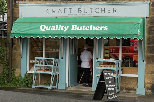 Exterior of a traditional butcher shop in Bellingham, UK, showcasing fresh meat and local produce.