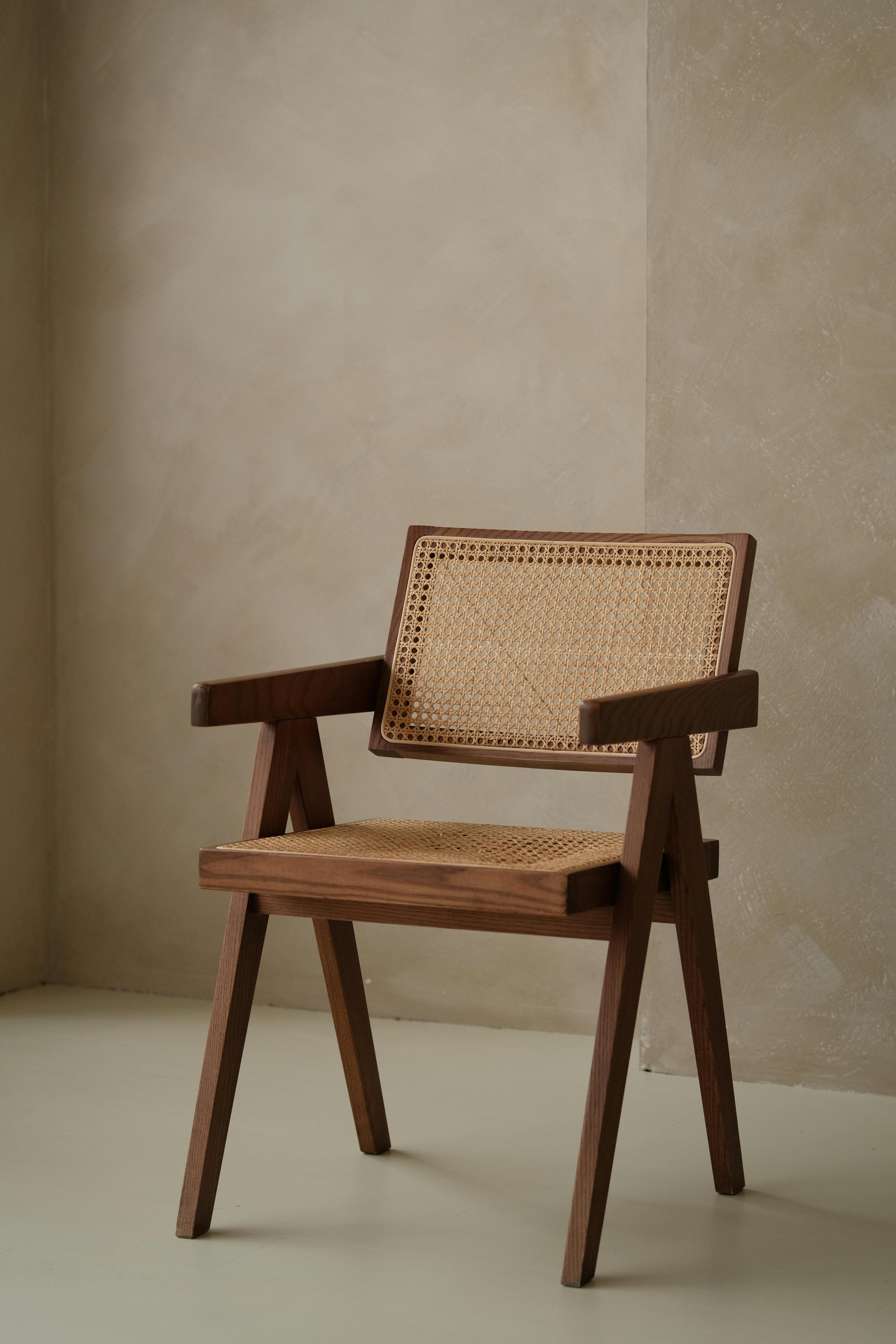 Elegant rattan chair with wood accents in a minimalist setting, highlighting earthy tones and a cozy ambiance.