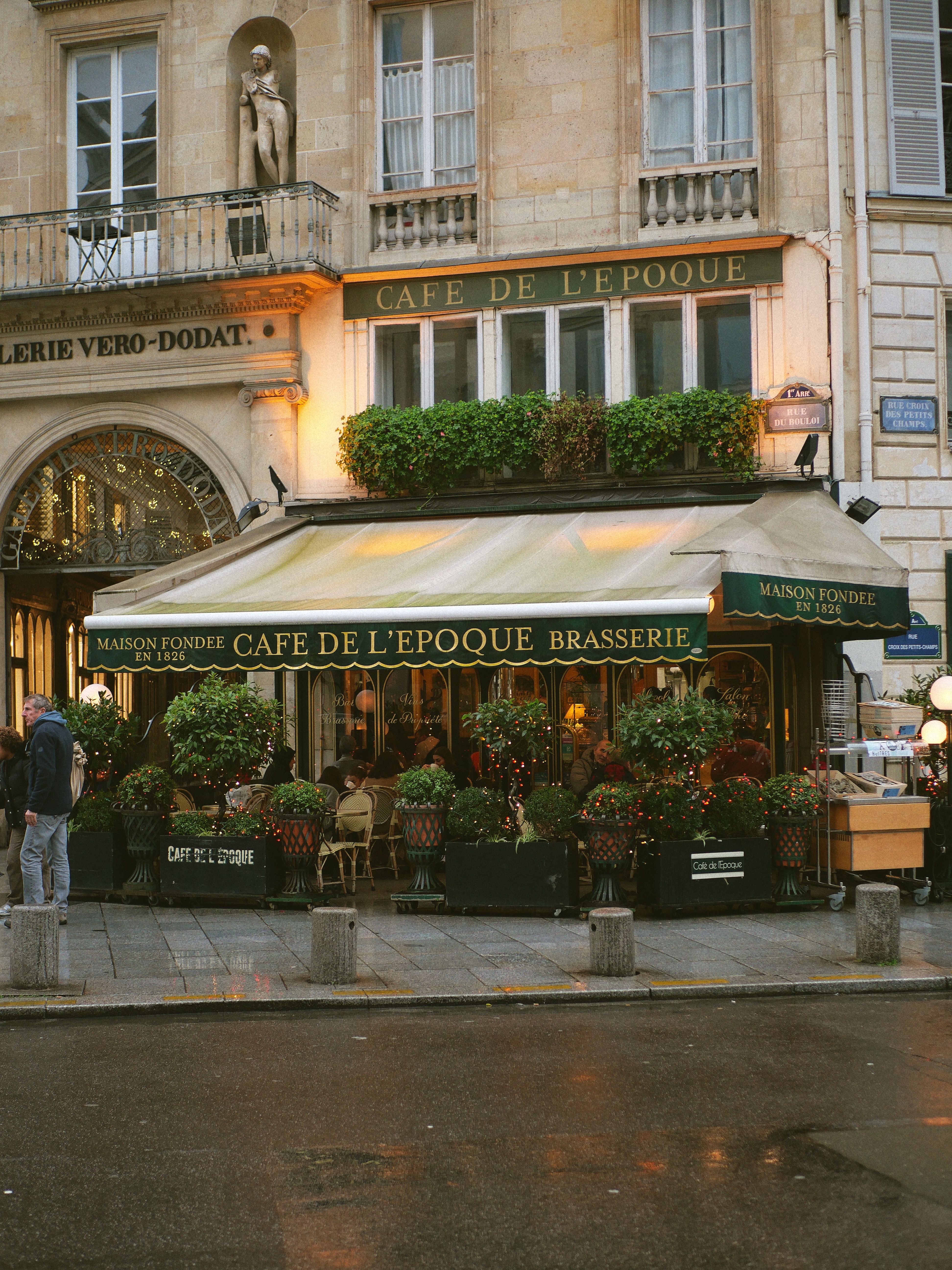 Quaint outdoor Paris café scene with rainy ambiance, perfect for travel themes.