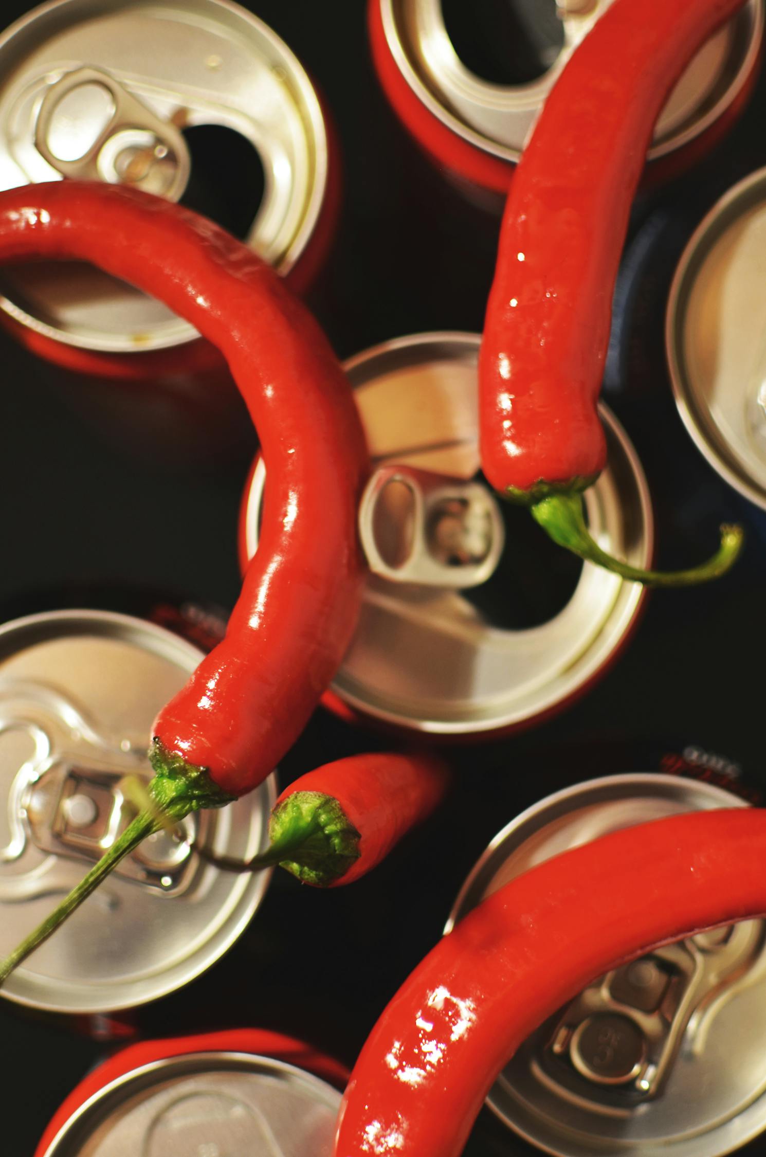 Four Red Chili on Top of Cans · Free Stock Photo