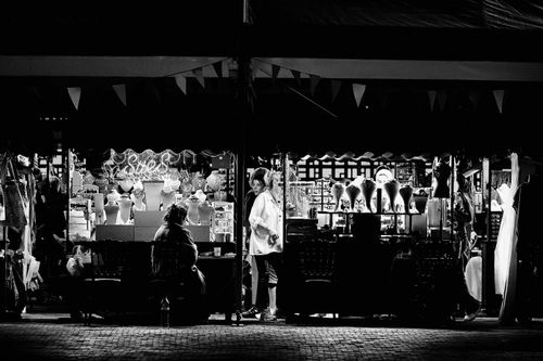 Free Black and white photo of a vibrant night market jewelry stall showcasing necklaces and accessories. Stock Photo