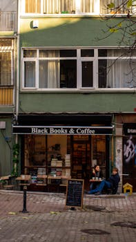 Cozy book and coffee shop in Istanbul's Kadıköy district, inviting ambiance with people enjoying books.
