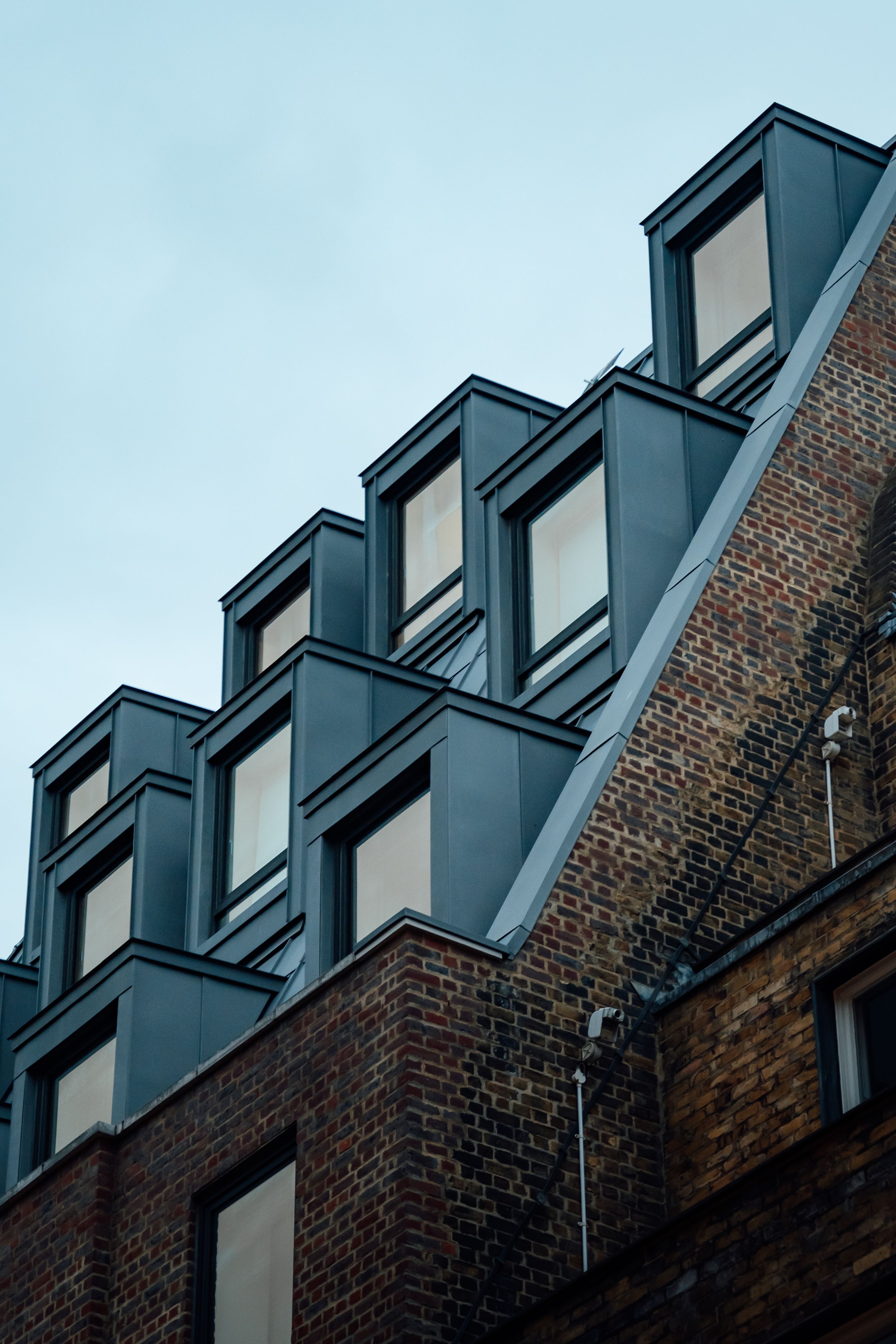 Modern Brick Building with Geometric Windows in London · Free Stock Photo