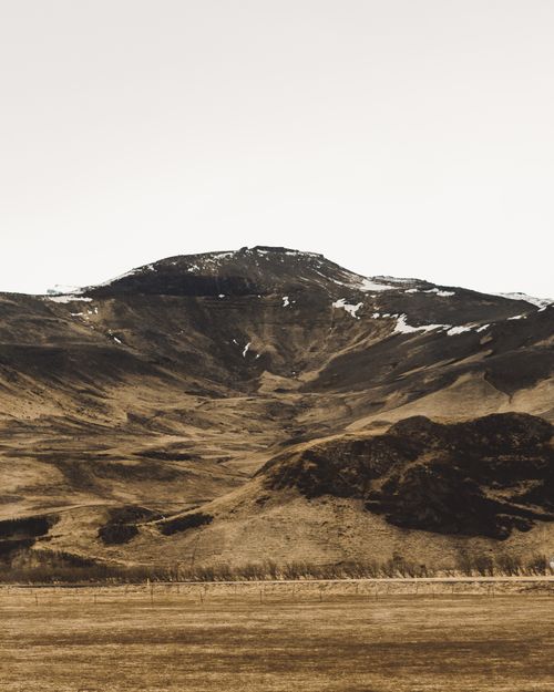 Free A stunning mountain landscape captured during early spring, showcasing rugged terrain and sparse snow patches. Stock Photo