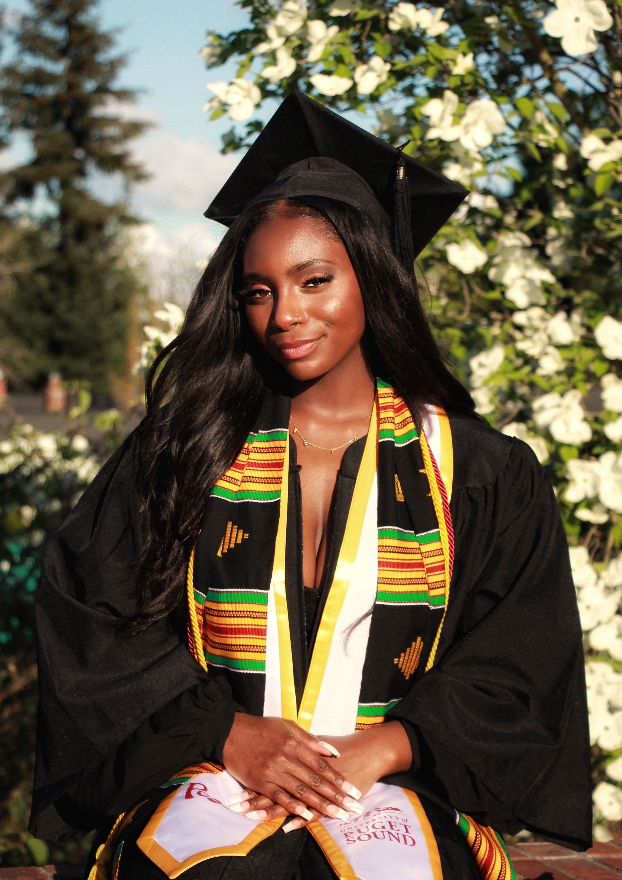 Young Graduate in Cap and Gown Standing Outdoors · Free Stock Photo