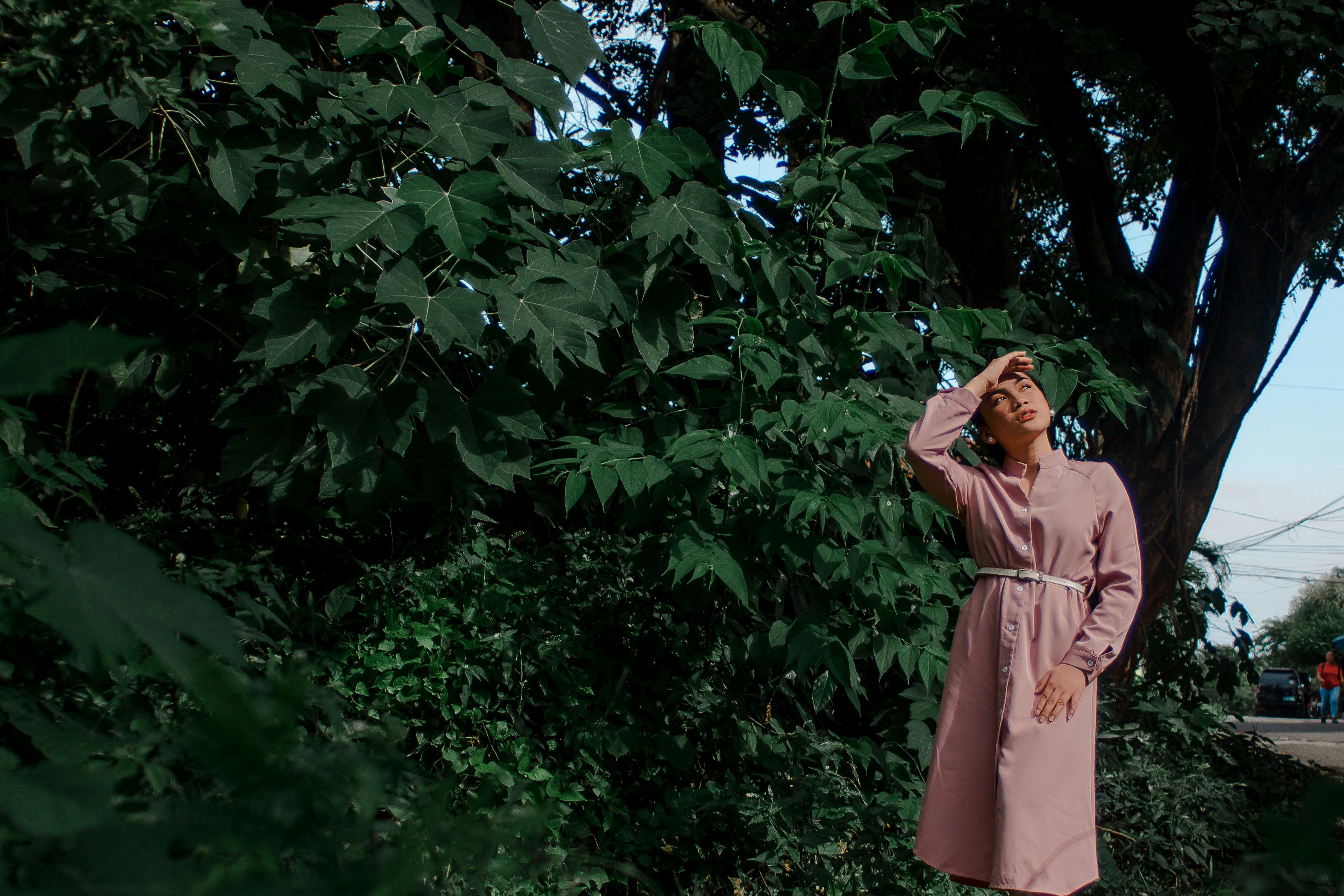 photo of woman standing near plants