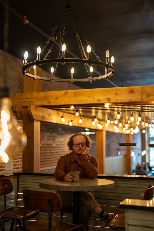Free A man enjoys a quiet coffee break in a warmly lit Stillwater cafe. Stock Photo