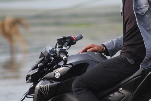 Close-up of a person on a Yamaha motorcycle enjoying an outdoor ride.