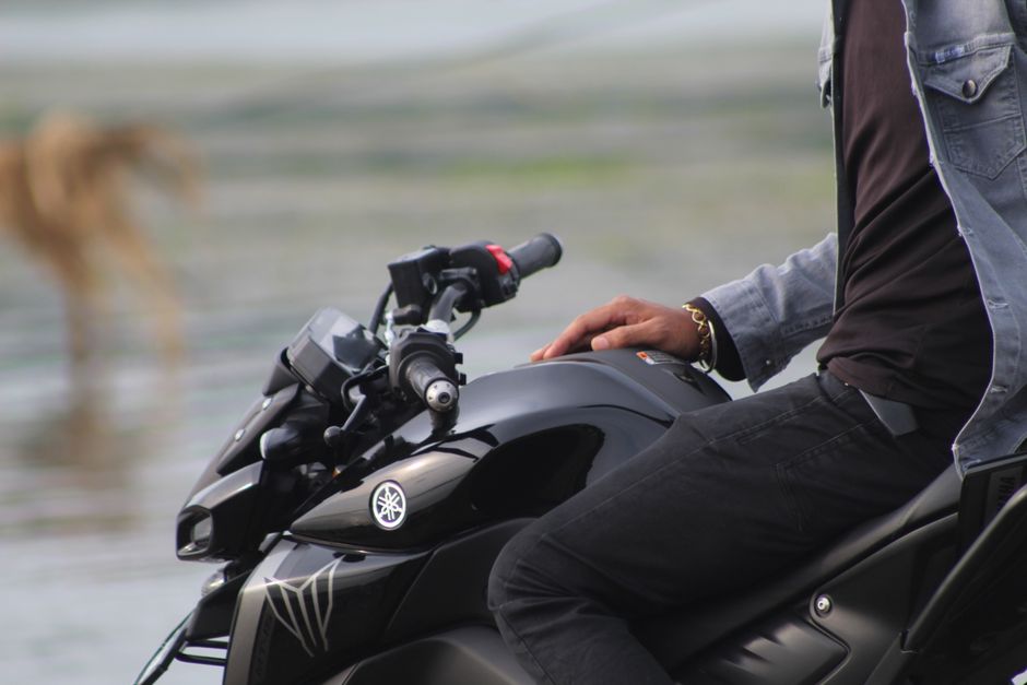 Close-up of a person on a Yamaha motorcycle enjoying an outdoor ride.