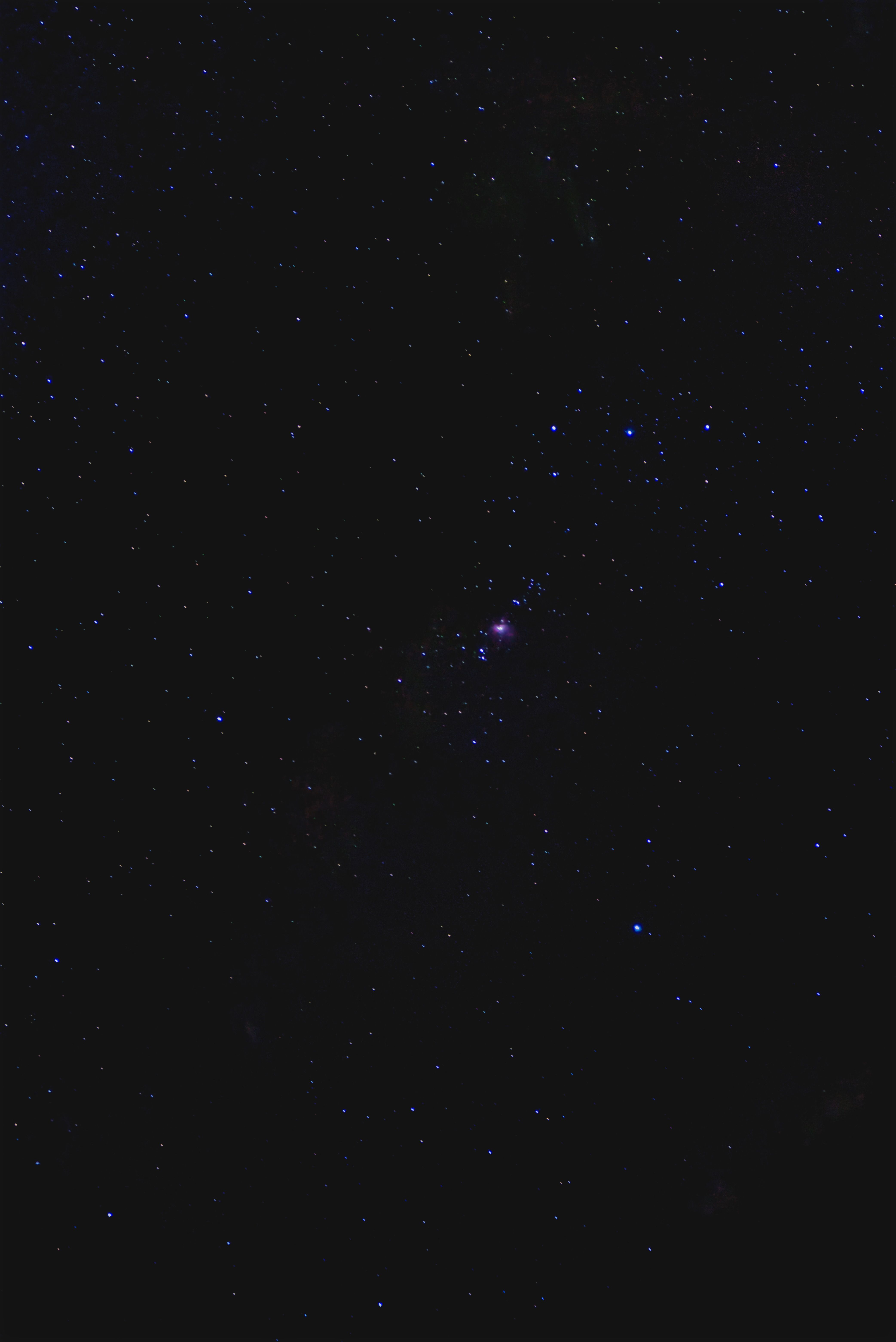A stunning view of stars with the Orion Nebula in a dark night sky.