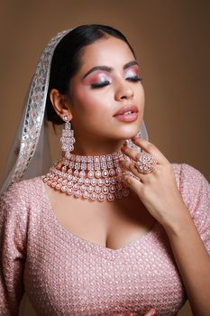 Stunning bridal portrait showcasing elegant jewelry and makeup in cultural attire.