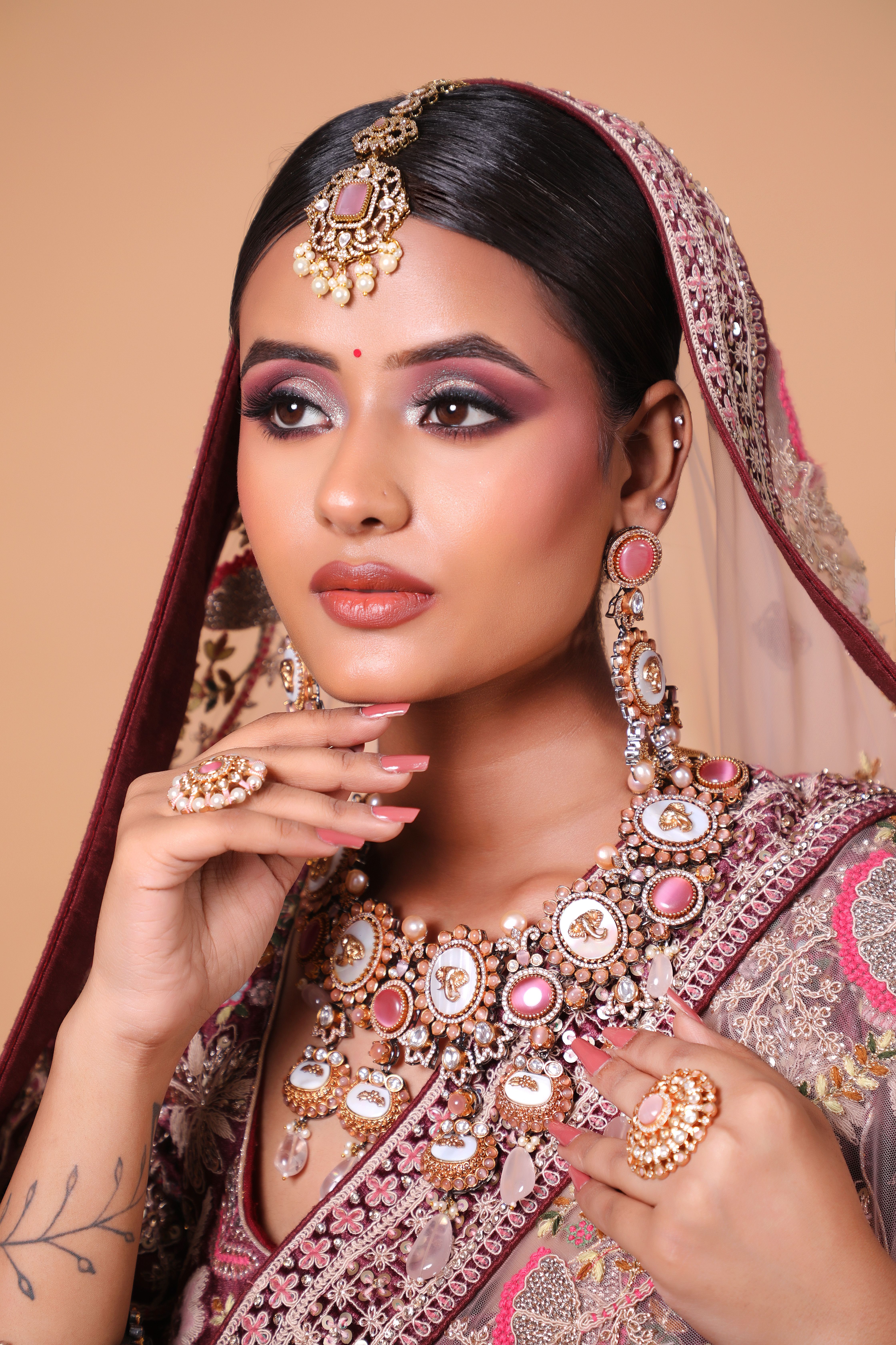 Graceful Indian bride in ornate jewelry and makeup, exuding elegance and tradition.