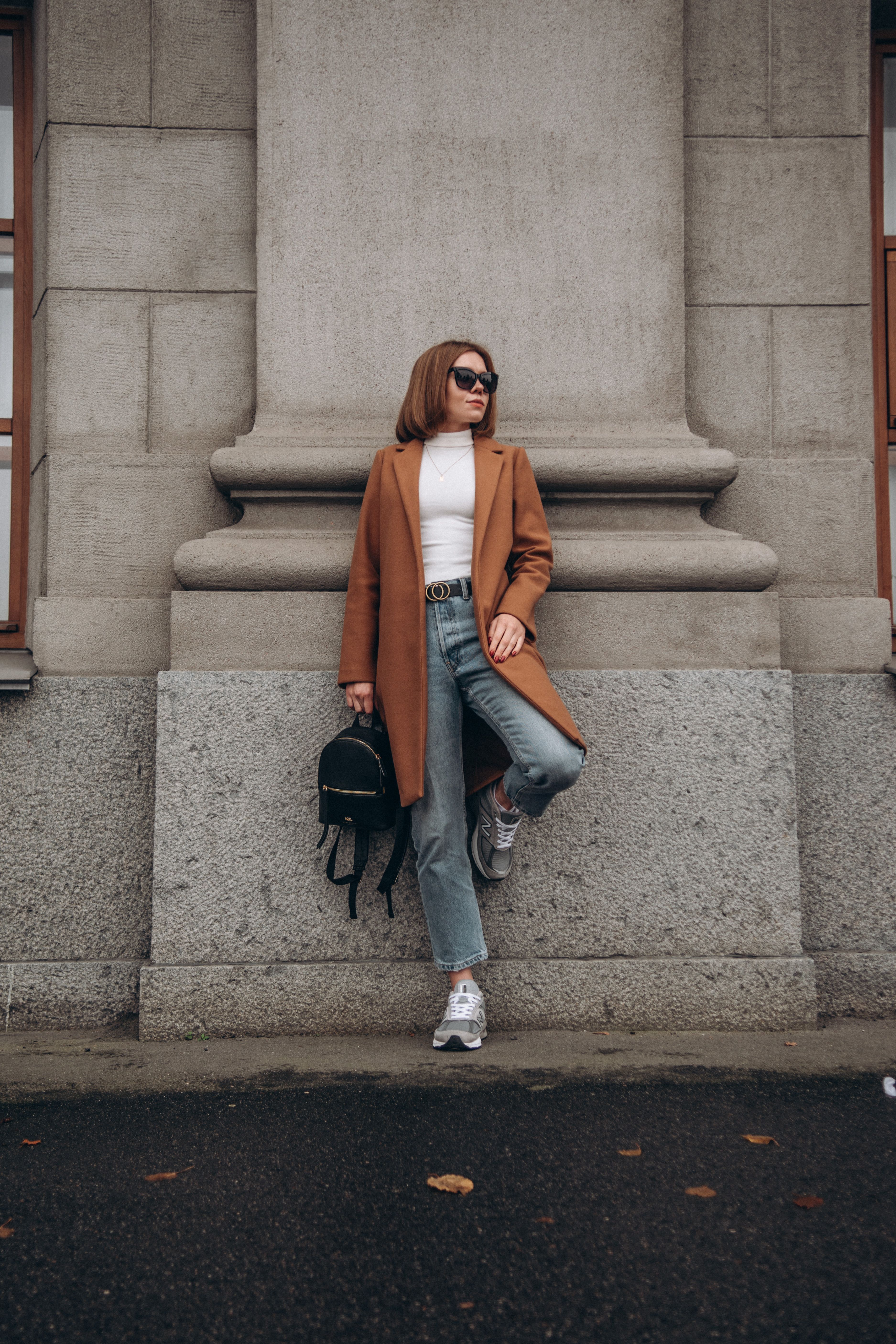 Woman in jeans with statement belt and flats