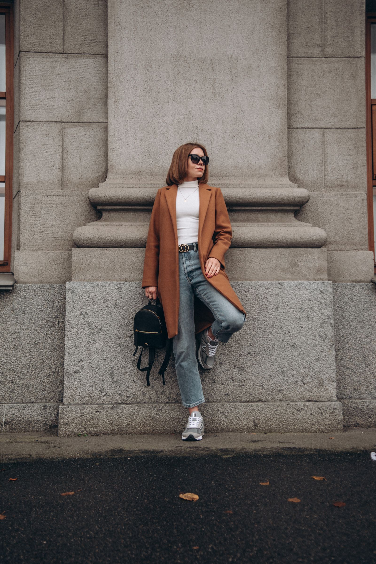 Woman in jeans with statement belt and flats