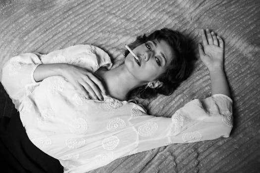 A dramatic black and white portrait of a woman smoking, captured indoors in Tehran, Iran.