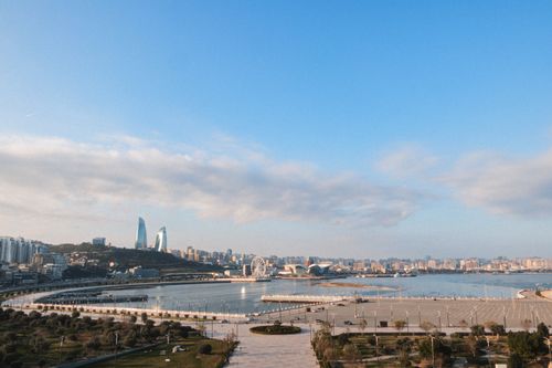 Free A scenic view of Baku featuring Flame Towers and the Caspian Sea, captured on a clear day. Stock Photo