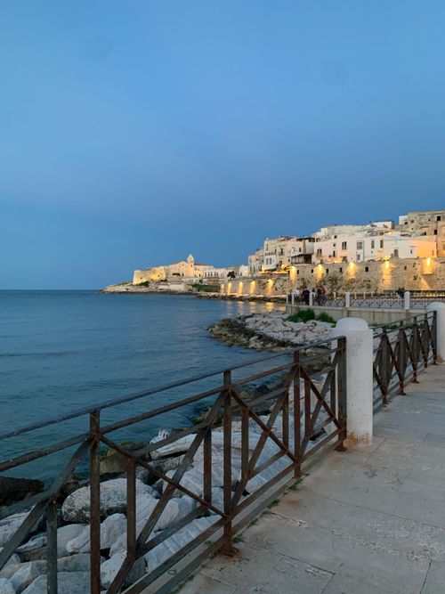 Free Beautiful coastal town with stone buildings overlooking the sea at twilight. Stock Photo