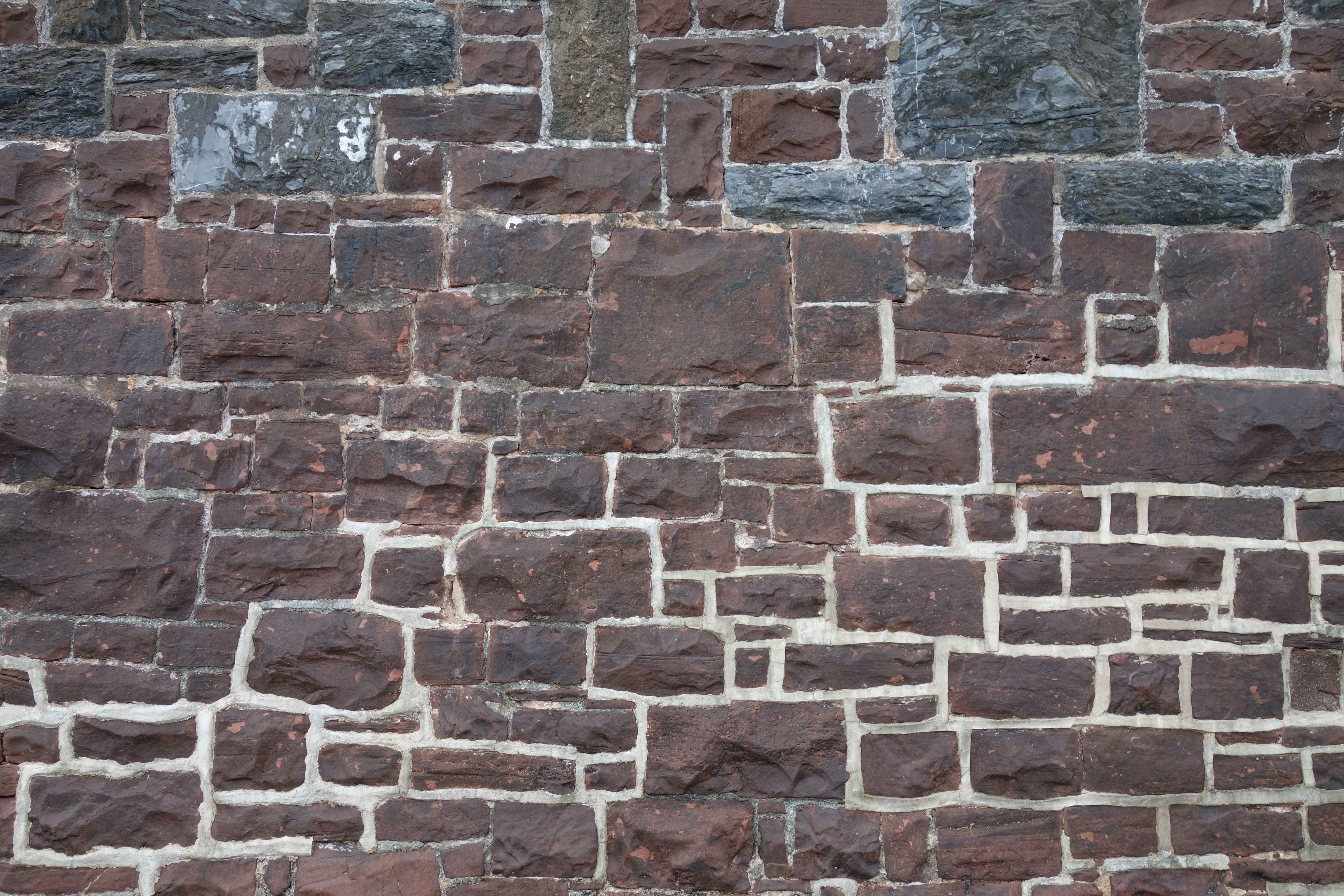 Rugged textured stone brick wall, perfect for backgrounds and architectural themes.