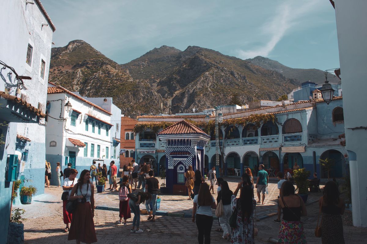 Explore the vibrant streets and rich culture of Chefchaouen, Morocco, with stunning mountain backdrops.