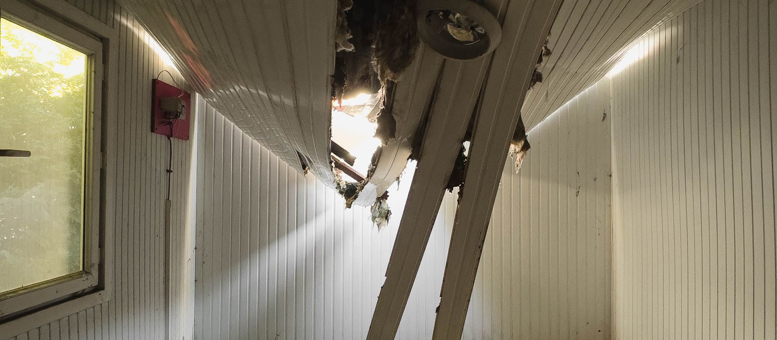 Room with a collapsed ceiling and debris on the floor