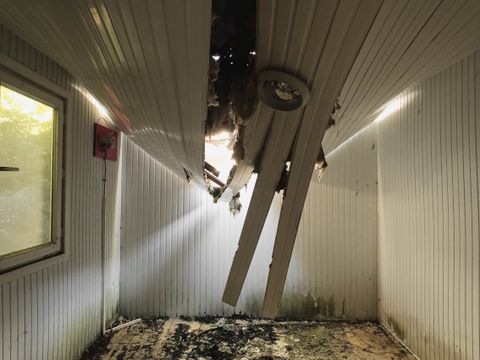 Room with a collapsed ceiling and debris on the floor