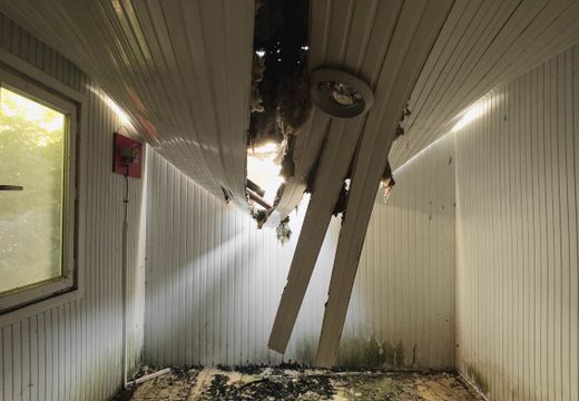 Room with a collapsed ceiling and debris on the floor