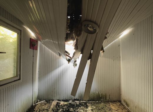 Room with a collapsed ceiling and debris on the floor