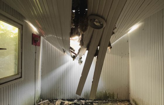 Room with a collapsed ceiling and debris on the floor