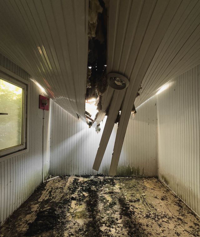 Room with a collapsed ceiling and debris on the floor