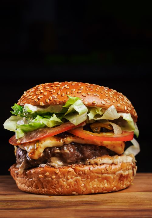 Free Mouthwatering cheeseburger with fresh ingredients, perfect for a casual meal. Stock Photo