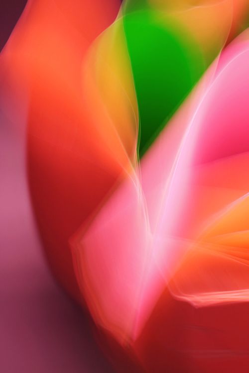 Free A colorful abstract light painting with vivid, blurred hues of pink, red, green, and orange. Stock Photo