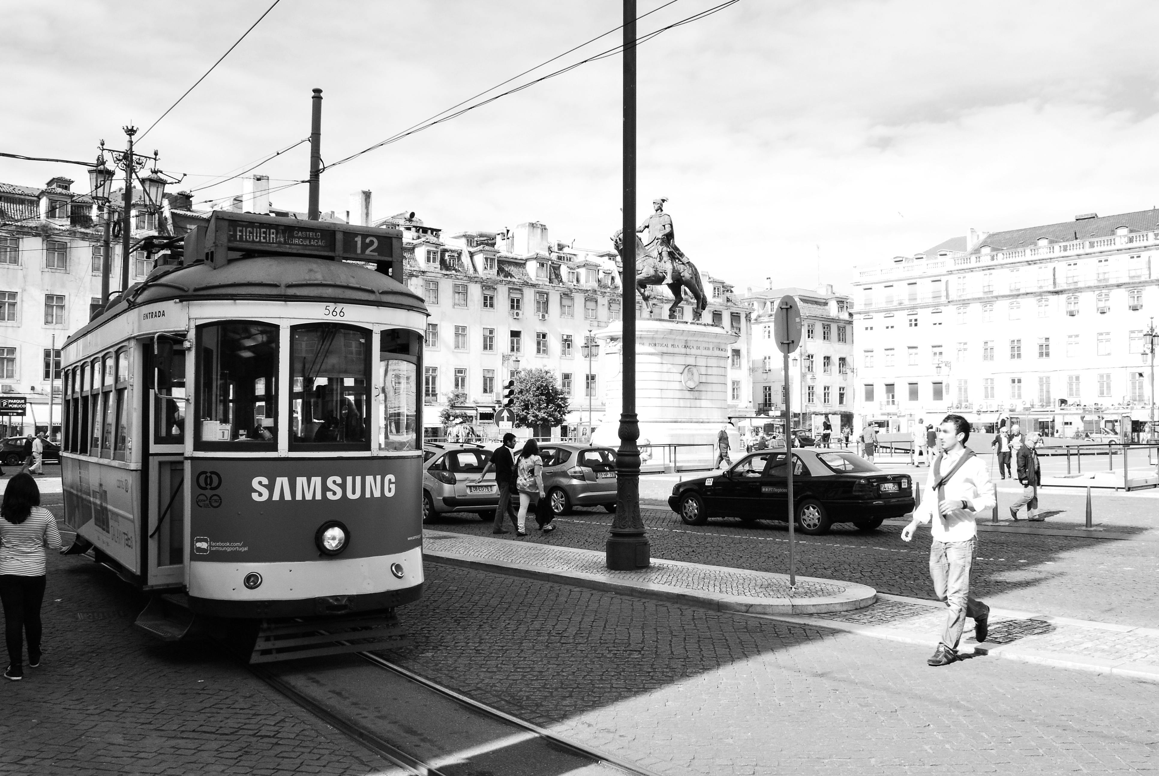 grayscale photography of man walking outdoors