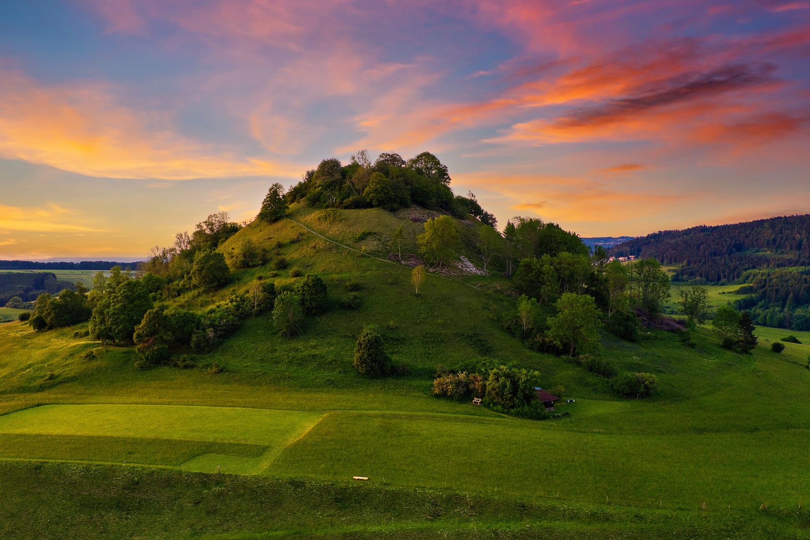 A green hill under a sunset sky — Friede Dia on Pexels
