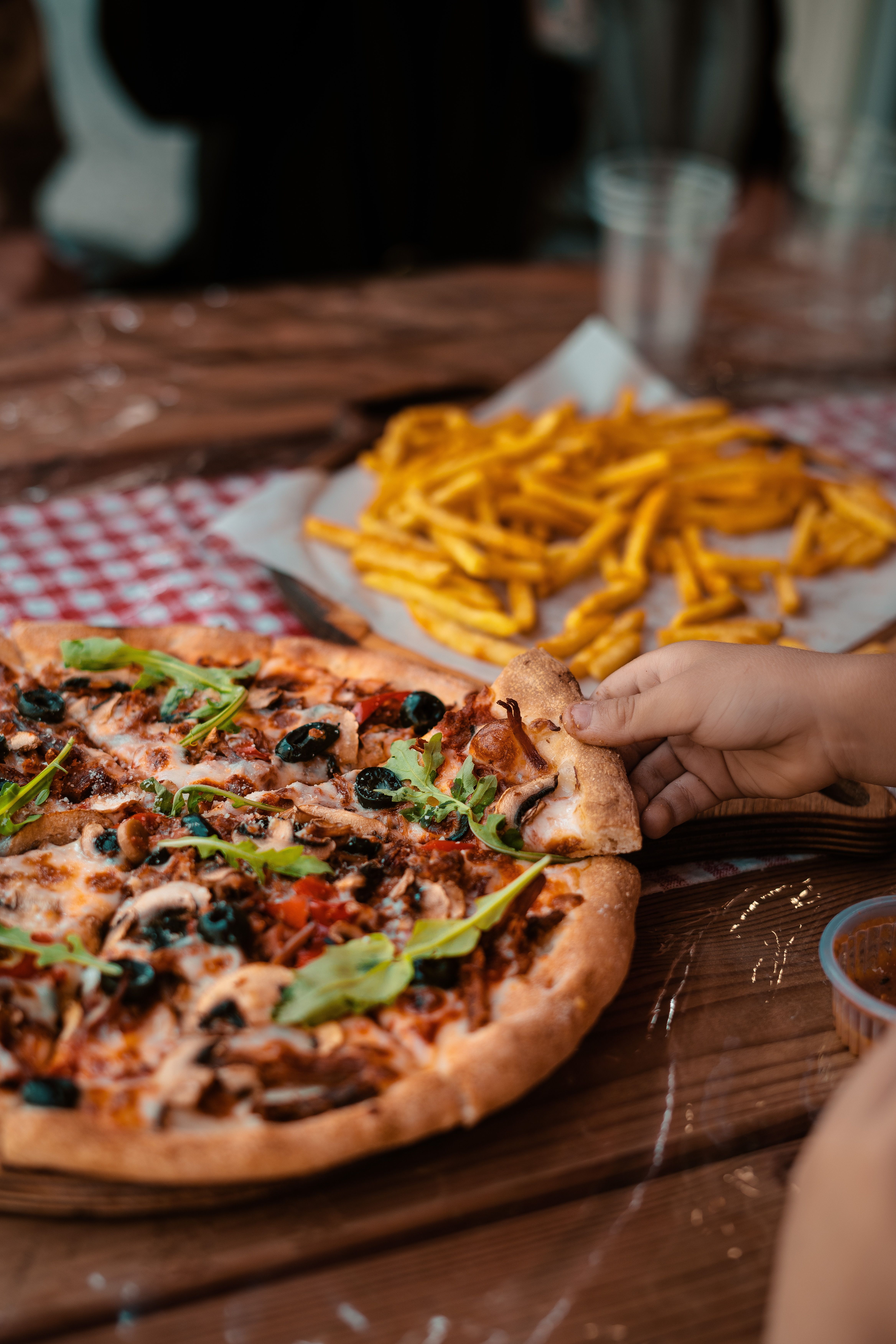 A tempting cheese pizza with toppings and fries, perfect for casual dining.