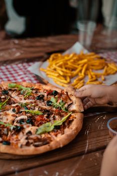 A tempting cheese pizza with toppings and fries, perfect for casual dining.
