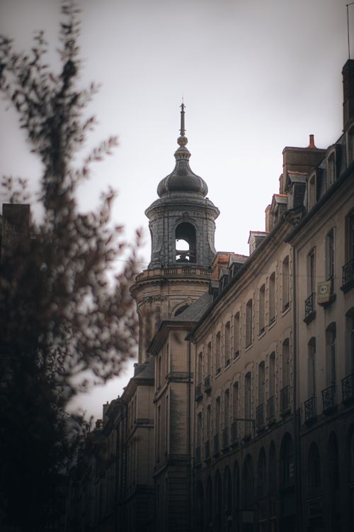 Free A classic European street scene featuring a historic clock tower and traditional architecture. Stock Photo