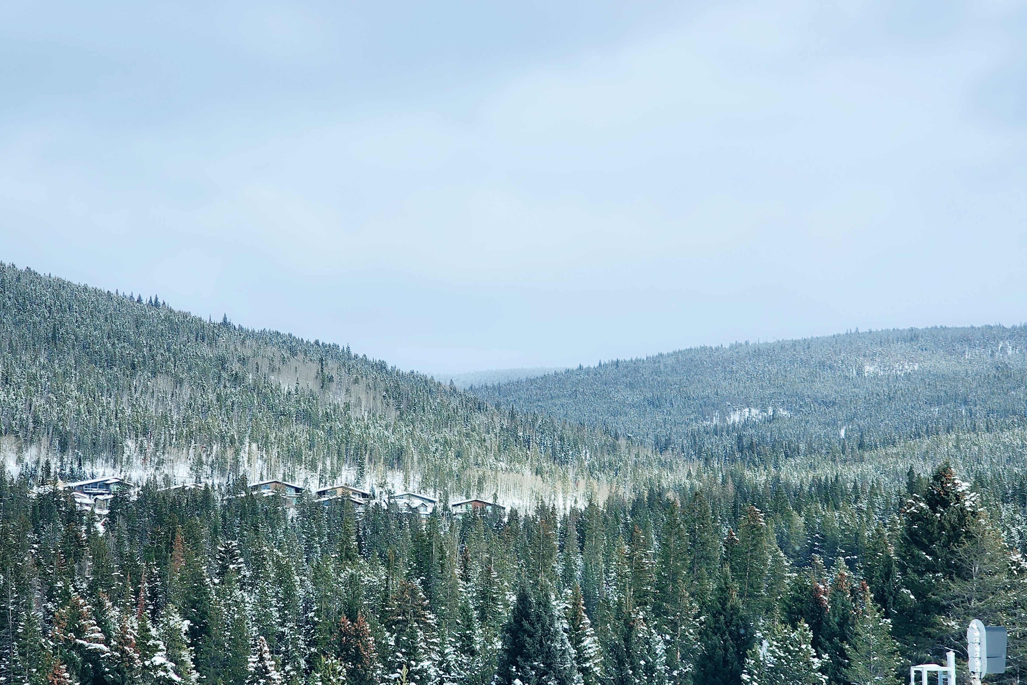 Scenic winter landscape of snowy mountains and forests in Winter Park, Colorado.
