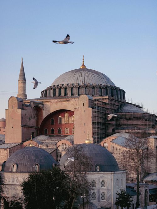 Free Stunning sunset view of the historic Hagia Sophia with flying birds in Istanbul, Turkey. Stock Photo