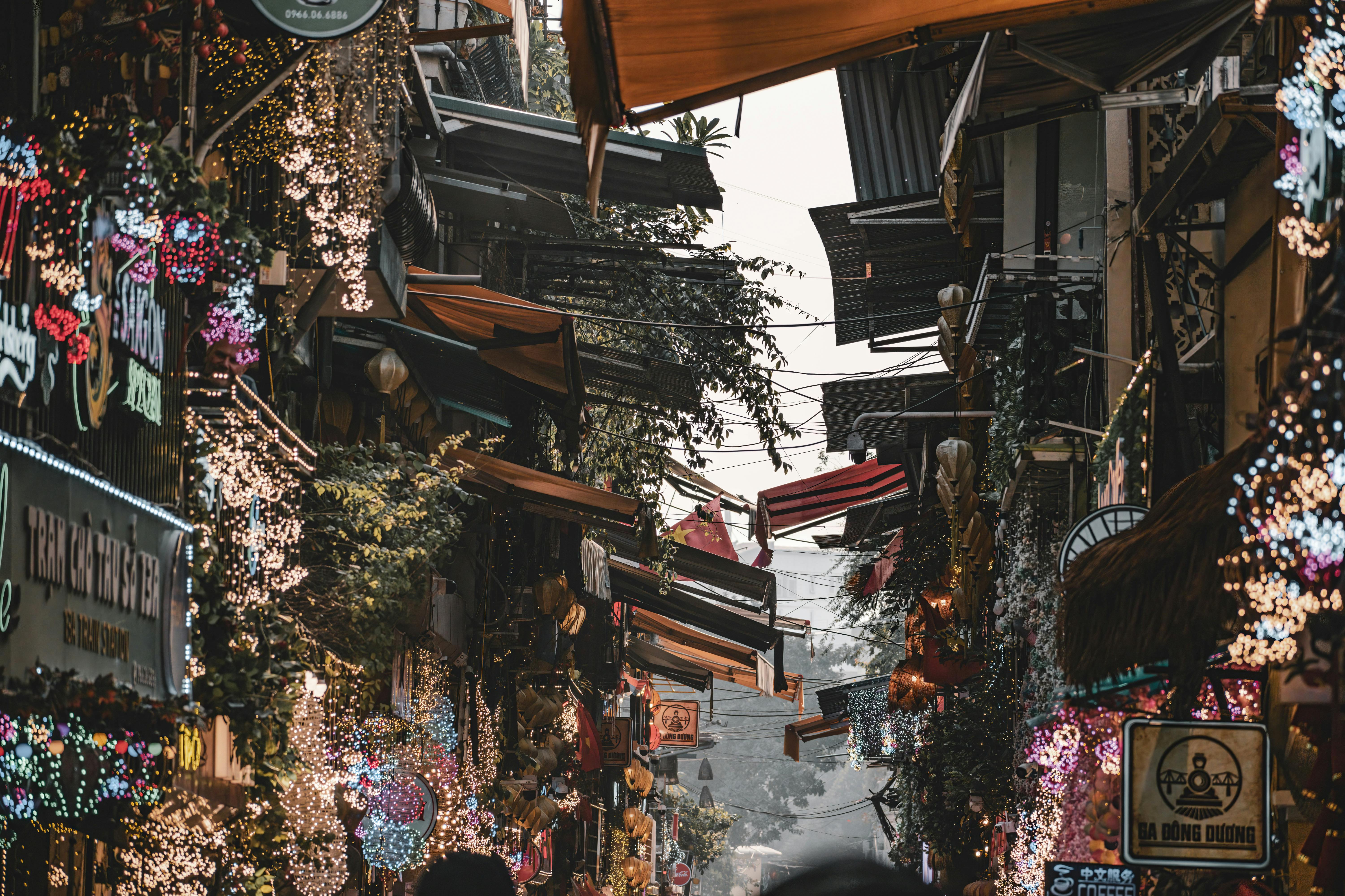Colorful Hanoi street with bustling activity and festive lights, showcasing Vietnamese culture.