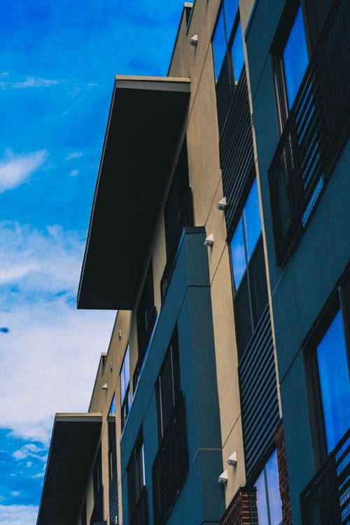 Free Low angle view of a modern building facade against a blue sky in Chattanooga. Stock Photo