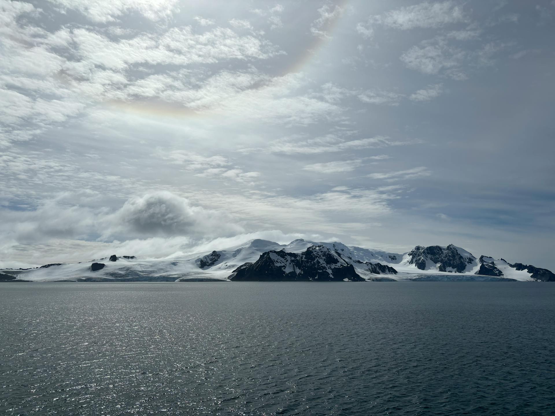 Breathtaking view of Antarctic glaciers and ocean under cloudy sky. Perfect for nature and travel themes.