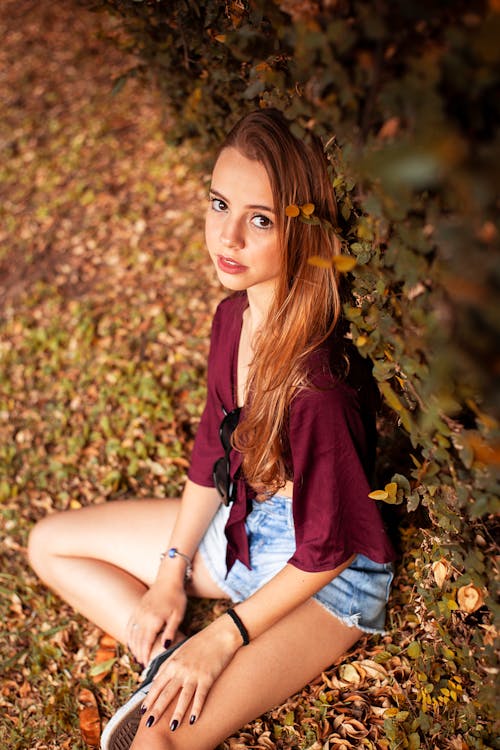Free High-Angle Photo of Girl Sitting on Grass Stock Photo