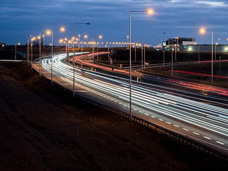 Dynamic light trails of traffic at night on Wrocław's highway.