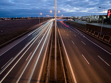 Long exposure of traffic on a night freeway in Wrocław, capturing streaks of light.