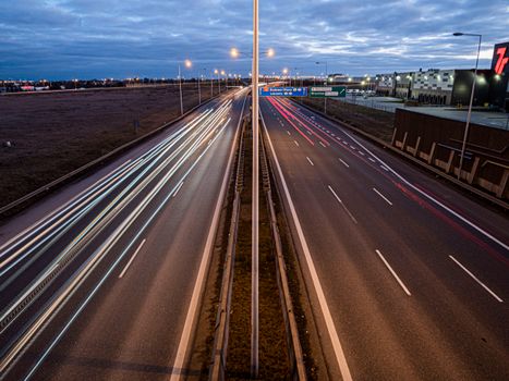 Captivating night view of Wrocław freeway showcasing light trails and urban infrastructure.