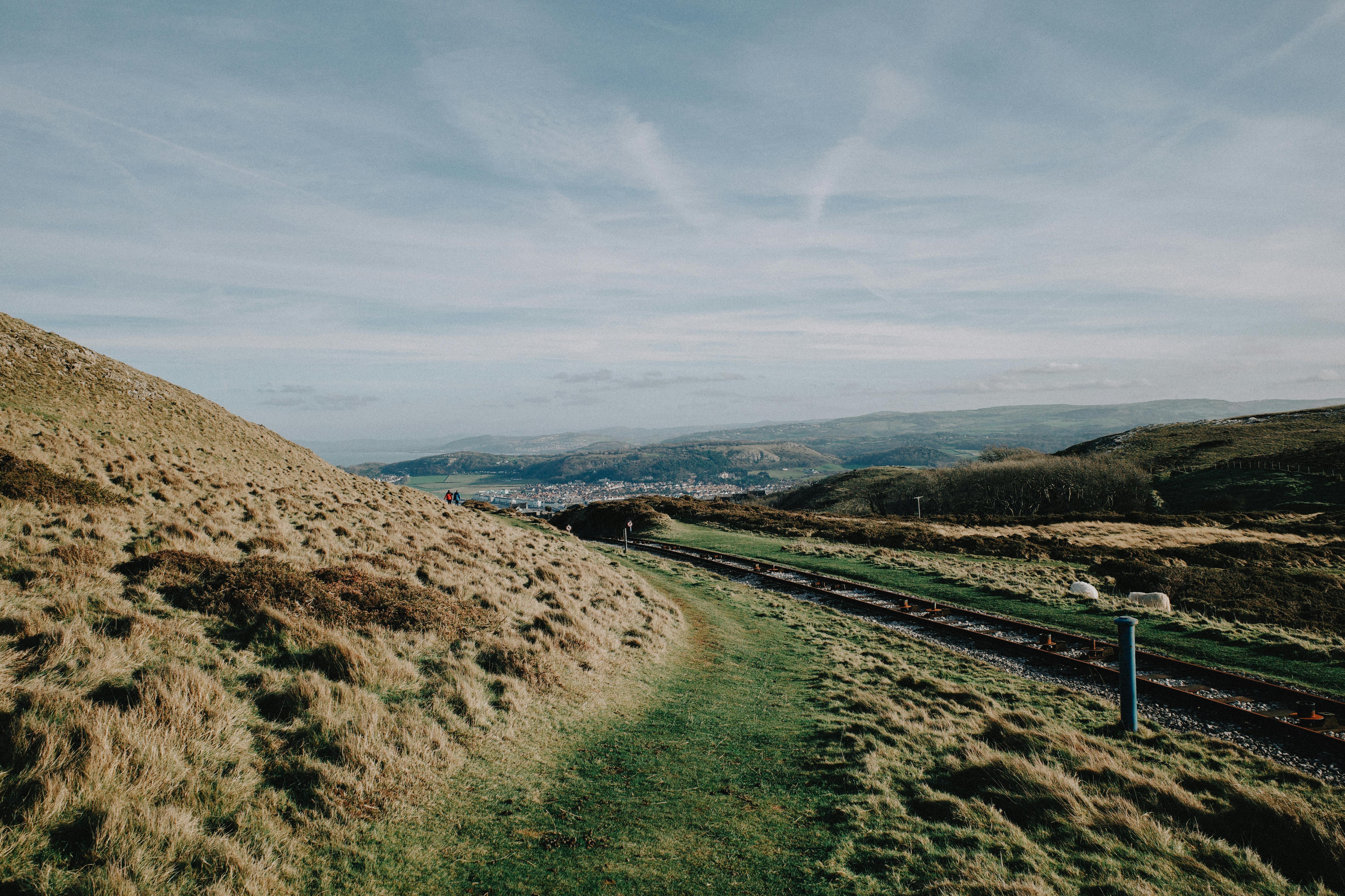 Explore the stunning landscape of rolling hills and coastal views in North Wales, UK.