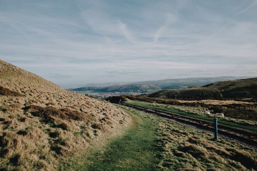 Explore the stunning landscape of rolling hills and coastal views in North Wales, UK.