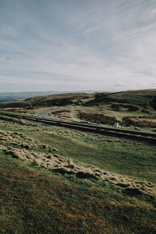 Free Captivating view of rolling hills and a winding road in Wales, UK. Stock Photo
