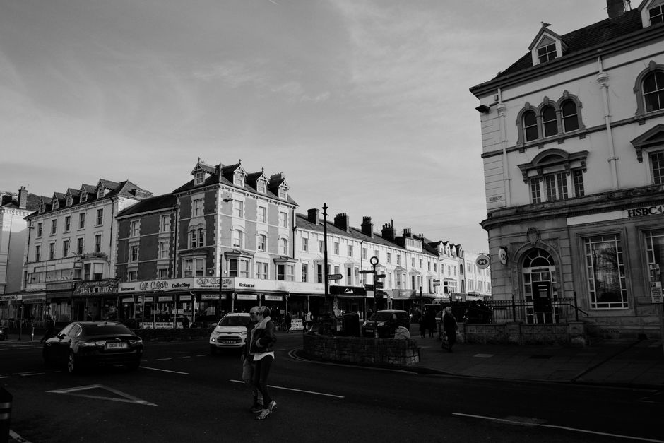 Black and white street view of Llandudno, showcasing classic architecture.