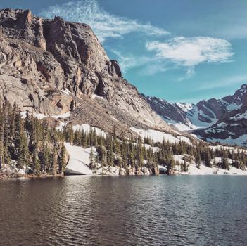 Beautiful rocky mountains and tranquil lake in Colorado during springtime.